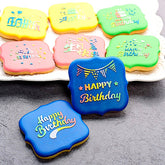Colorful birthday-themed cookies decorated using happy birthday stencils.