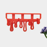 An red plastic chocolate drip border cutter for fondant cake design